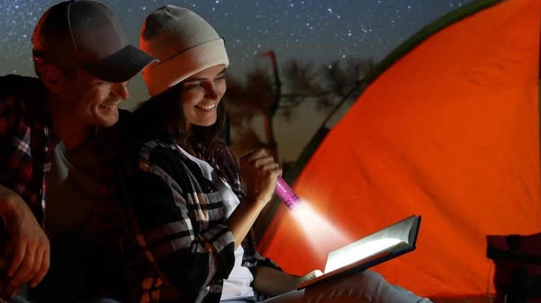 Couple using EverBrite flashlight to read