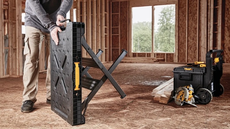 Person folding up DeWalt Workbench