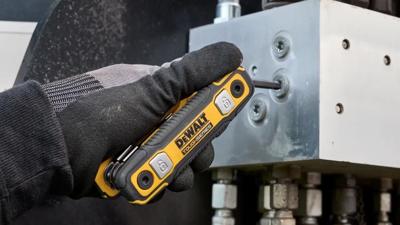 Person holding folding DeWalt hex key set