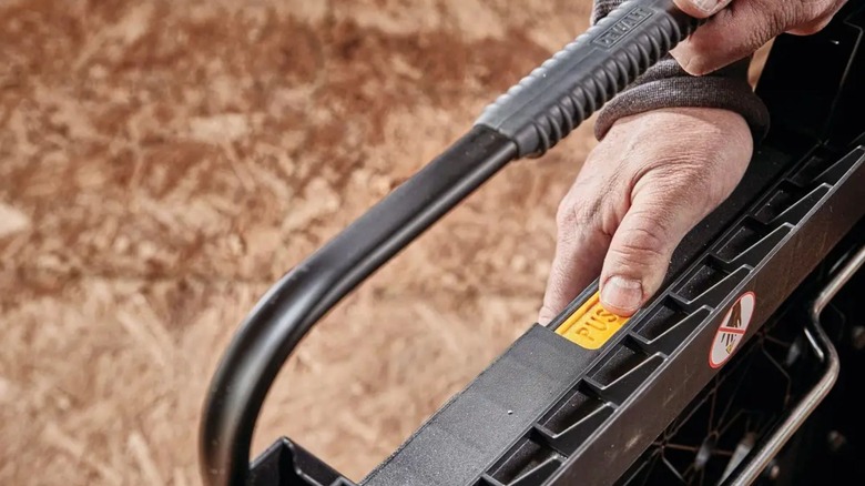 man closing DeWalt Portable Sawhorse Workbench