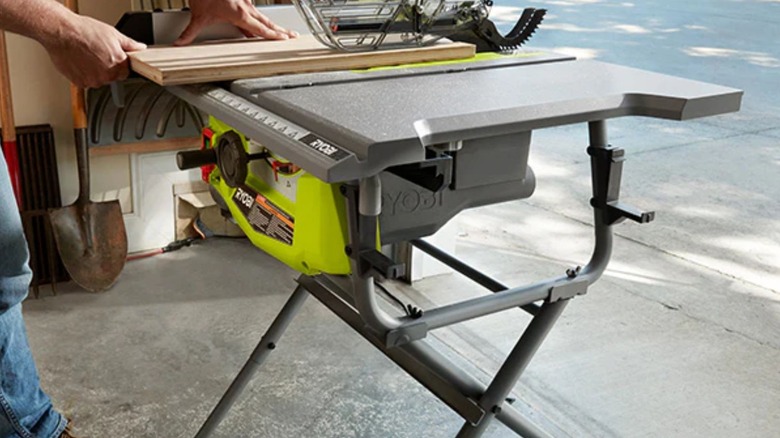 Man using Ryobi Table Saw with Folding Stand