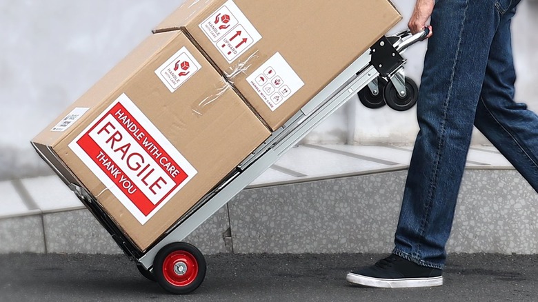 man moving boxes with Vevor Folding Hand Truck