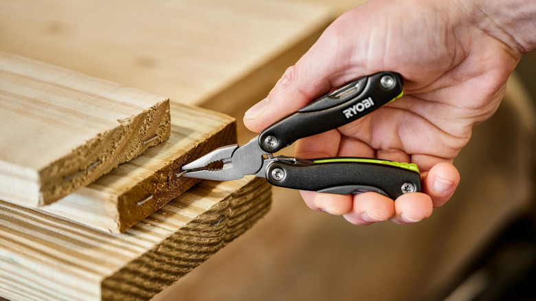 A person holding Ryobi multi tool