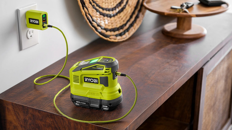 A Ryobi wall charger charging Ryobi inverter kept on a table