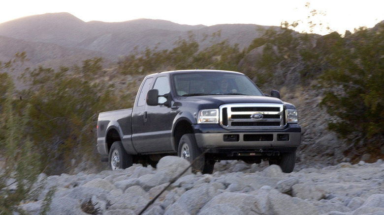 2006 Ford F-350 on rocky terrain, front-right 3/4 view