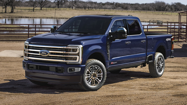 Front 3/4 view of dark blue Ford F-350 parked at ranch.