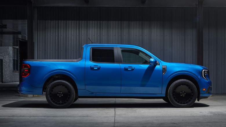 Side view of blue Ford Maverick Lobo parked in garage.