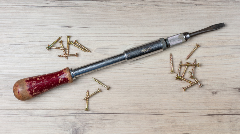 Vintage Stanley Yankee screwdriver on wood with wood screws