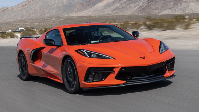 Front 3/4 view of orange 2020 Corvette Stingray on desert race track.