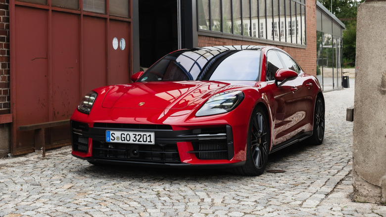 Porsche Panamera GTS parked next to an old warehouse