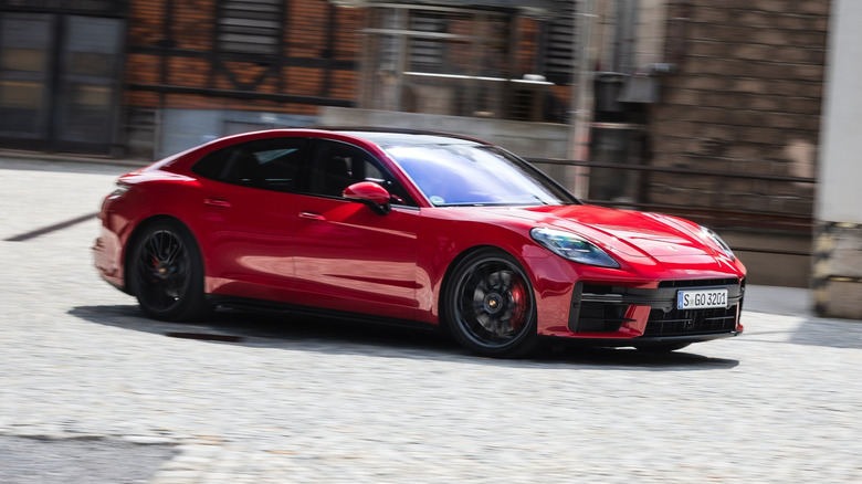 Porsche Panamera GTS driving past an historic building