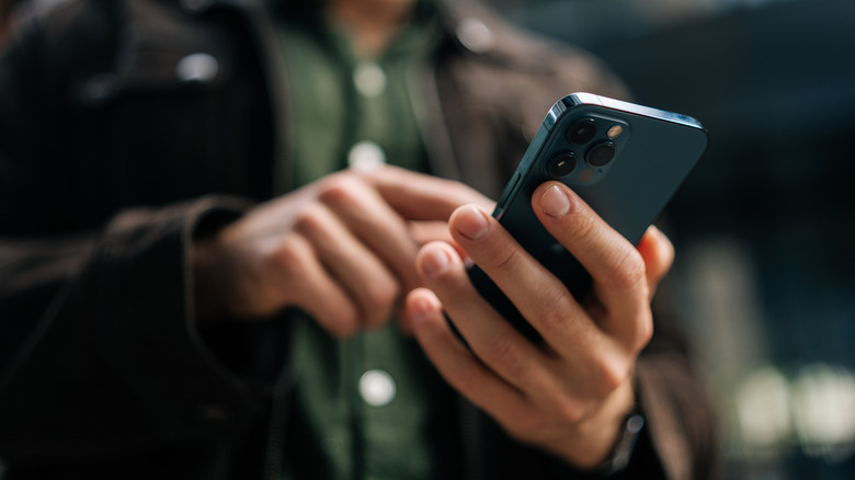 Person using a finger to tap a smartphone screen