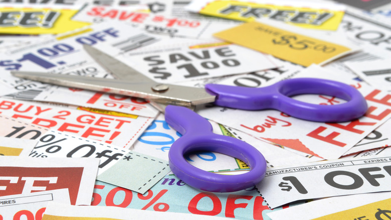 Collection of coupons with a pair of purple-handled scissors