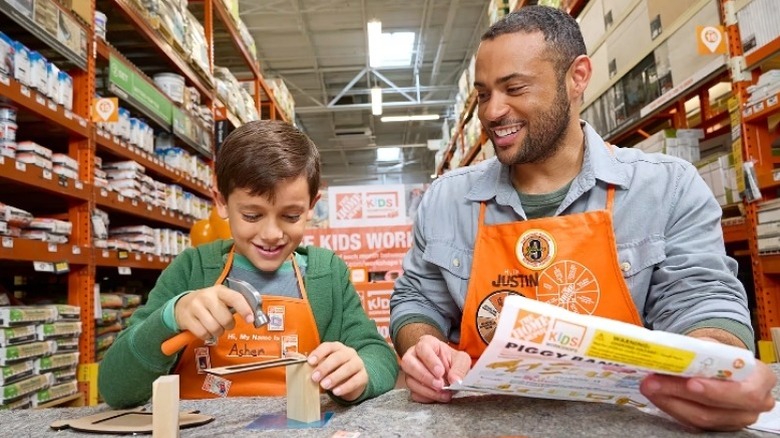 Man teaching child how to build a wooden project