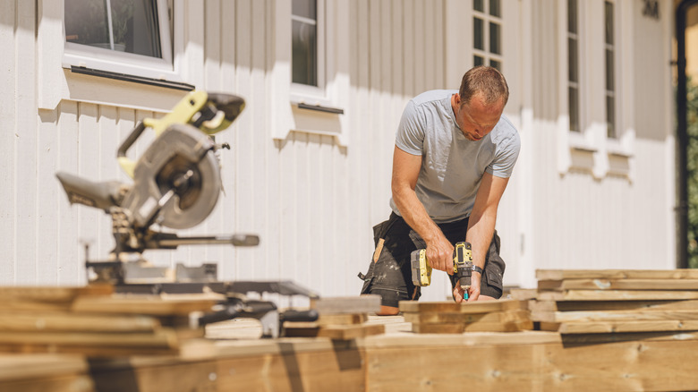 Man drilling holes into wood