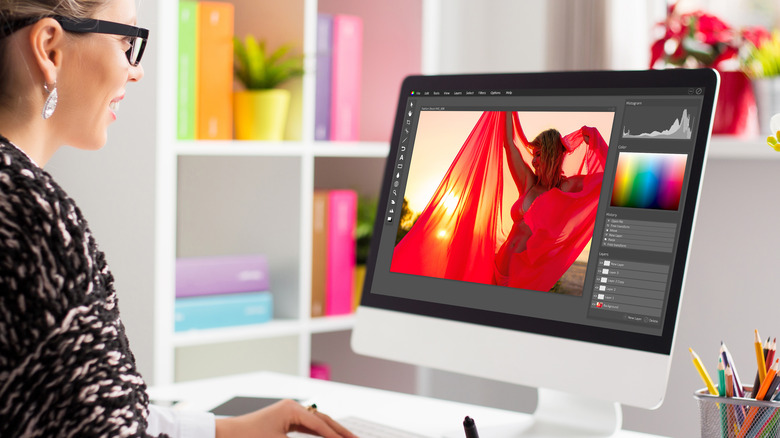 person editing image at desk