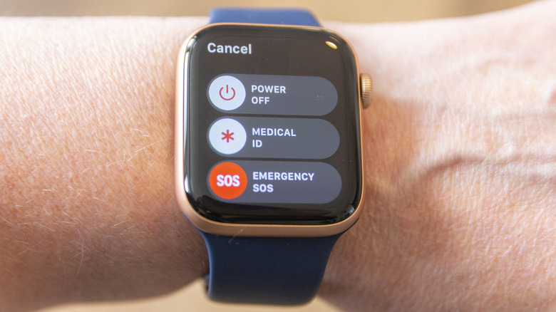 person wearing an Apple Watch Series 6 with a blue strap with the screen showing the power menu