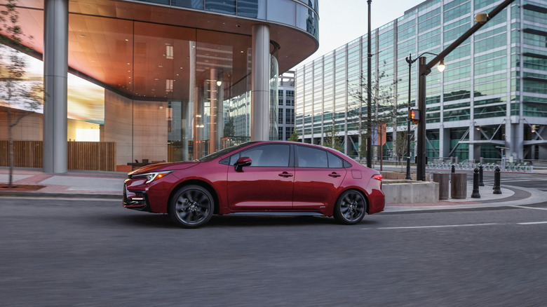 A Red 2026 Toyota Corolla Hybrid SE model shown parked on the street