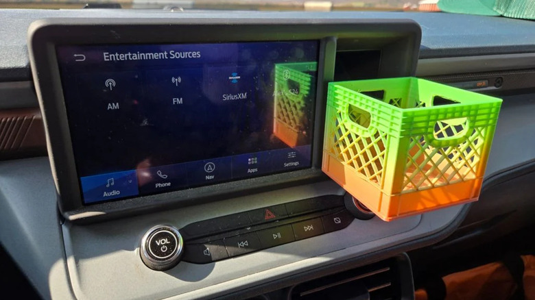 A 3D-printed crate attached to the dashboard of a Ford Maverick