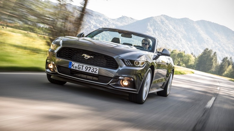 Ford Mustang convertible driving on a road