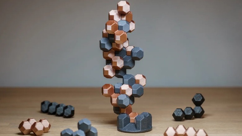 HedronStack game on table surrounded by other pieces