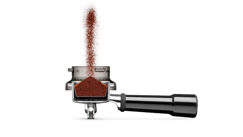 Picture showing coffee grounds dispensing into a dosing funnel