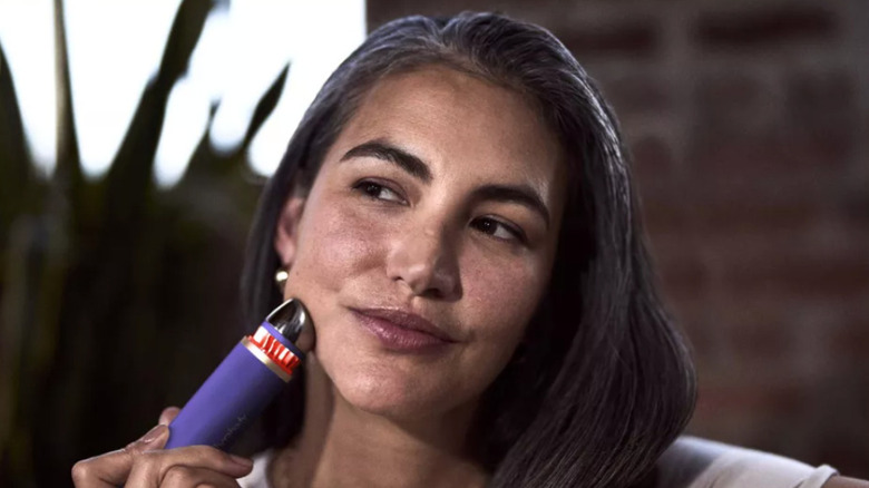 Therabody's TheraFace device being used on woman's face