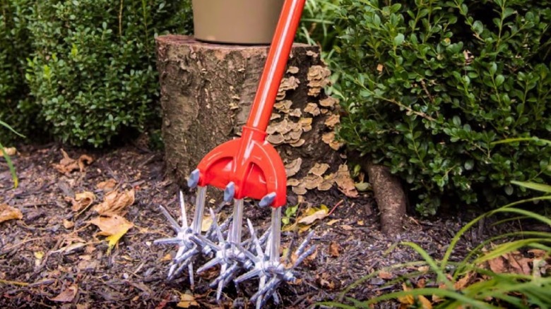 A Garden Weasel cultivator outside in the yard