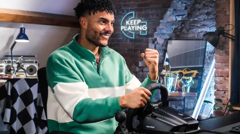 man using steering wheel controller