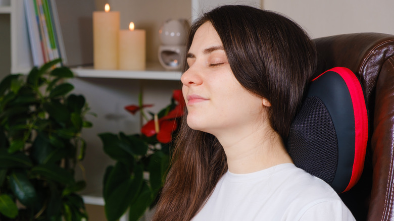 Woman laying on a massage pillow