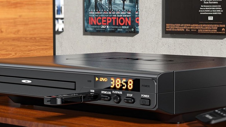 DVD player on table with the Inception movie poster in the background