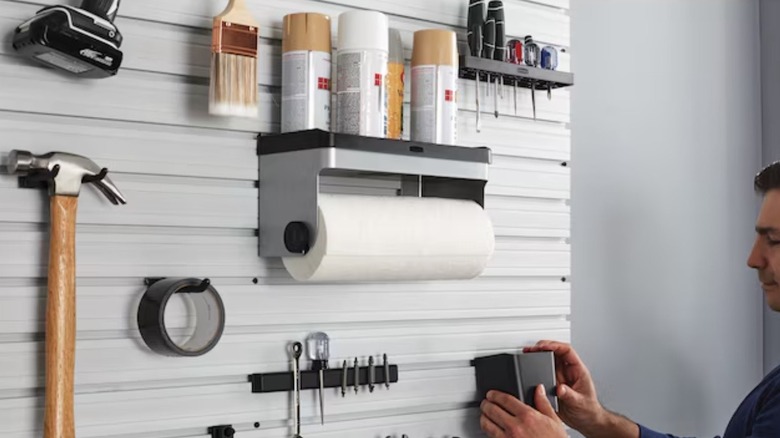 Person working in garage near Rubbermaid Paper Towel Holder