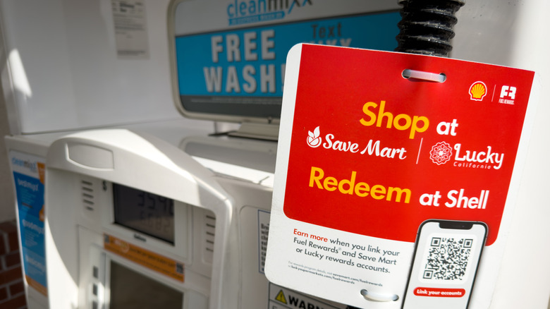 a rewards program sticker is seen on a gas station pump