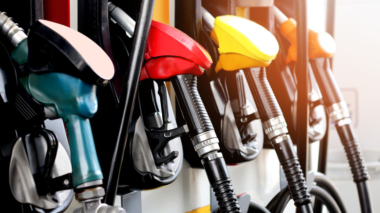 different colored gas pumps at a gas station are shown up close