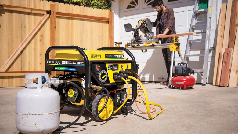 Champion 201223 generator hooked to a gas tank, running a table saw.