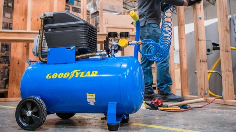 A Goodyear 10-gallon portable compressor at a jobsite.