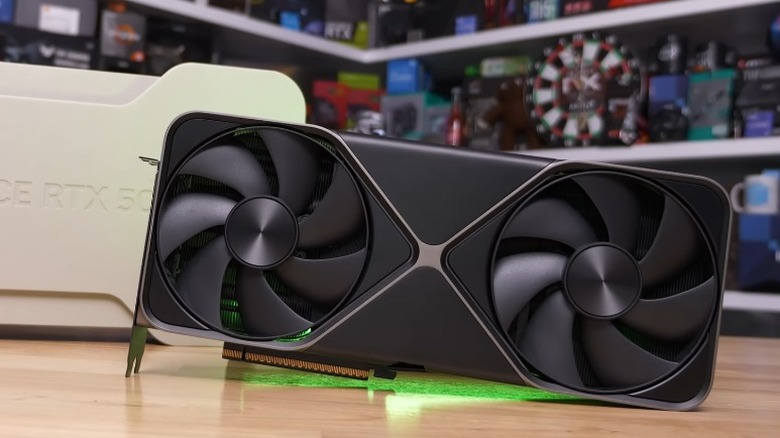 Nvidia GeForce RTX 5080 Founders Edition on a table in front of its box.