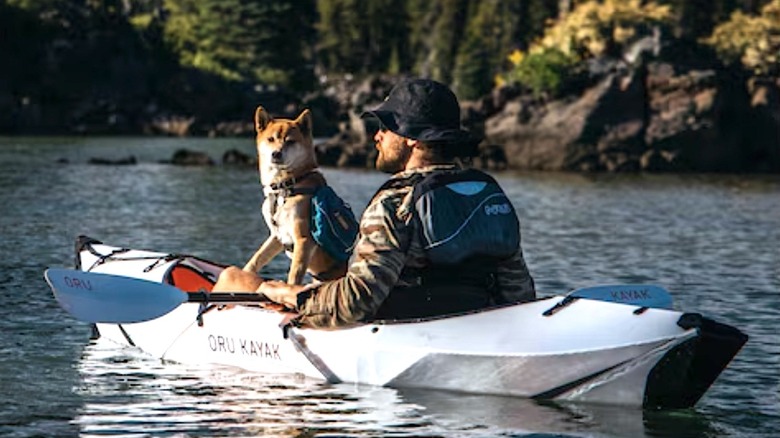 Person using Oru kayak with their dog