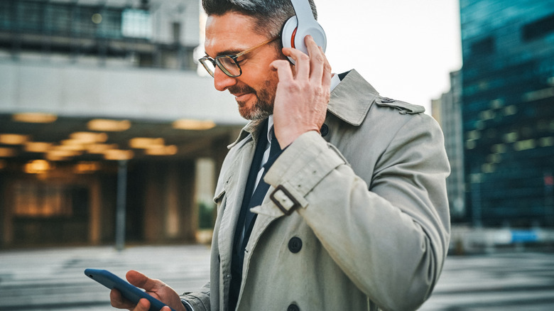 Catching up with podcasts during his morning commute.