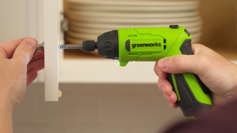 A person using a Greenworks power screwdriver.