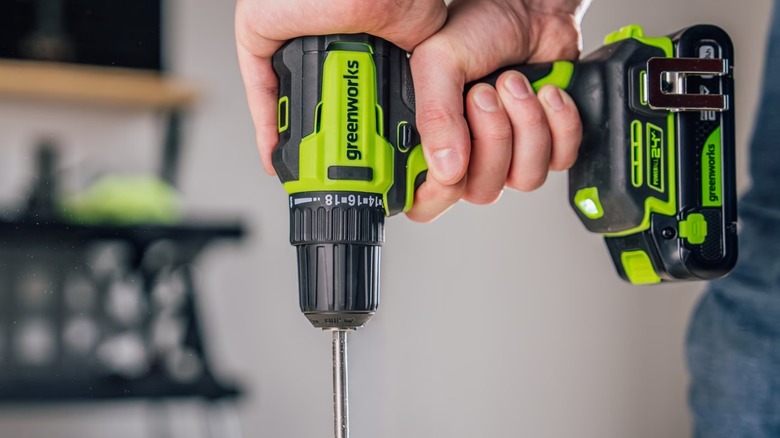 A person using a Greenworks PowerAll drill.