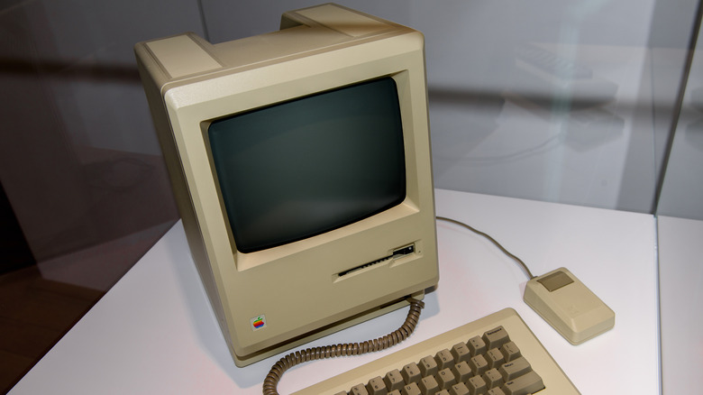 1984 Apple Macintosh personal computer with keyboard and mouse on display