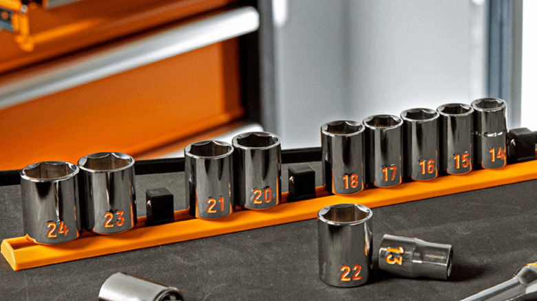 A set of Gearwrench sockets on a work table.