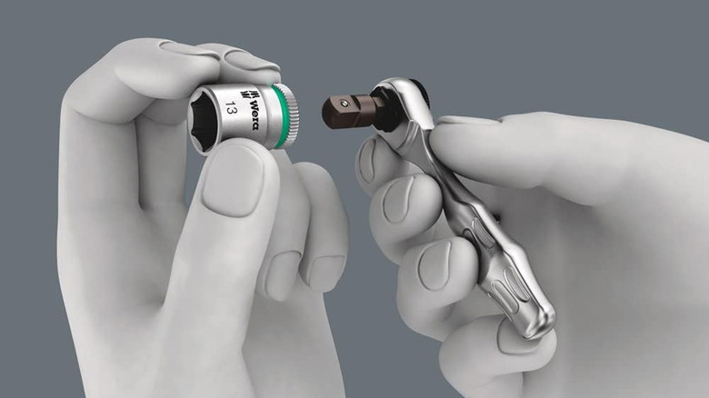 A CGI representation of hands holding a small Wera ratchet.