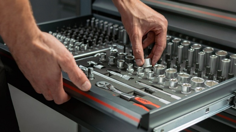 Hand reaching for a Sonic Tools socket
