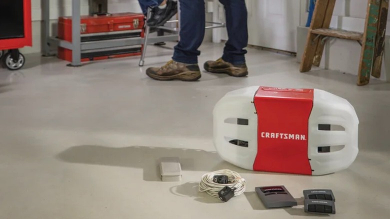 Craftsman myQ Smart Belt Drive Garage Door Opener and accessories placed on garage floor