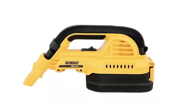 Person using a DeWalt vacuum to clean a car