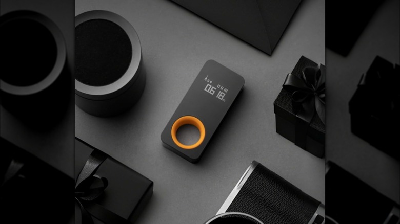 HOTO laser measuring tool on a gray surface with black boxes around it