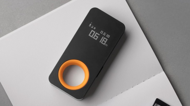 HOTO laser measuring tool on a blank notebook