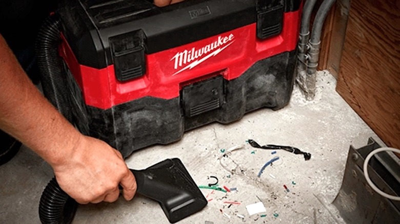 Person using Milwaukee Wet-Dry Vac